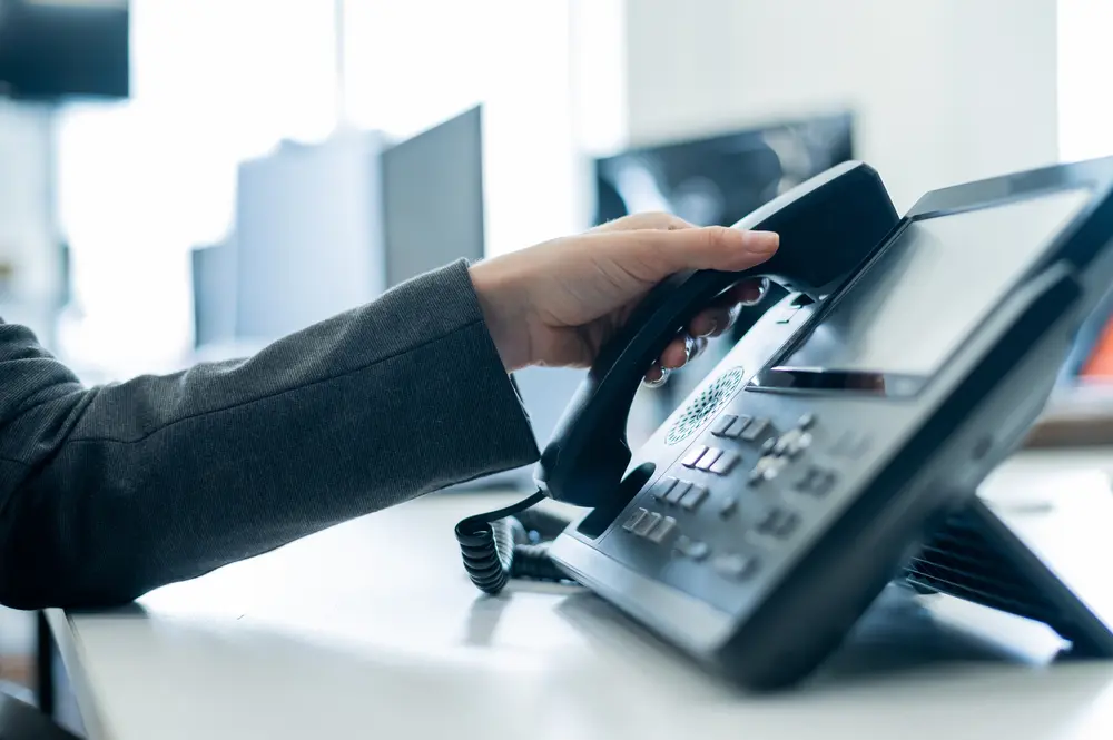 Close up of female hand answering phone