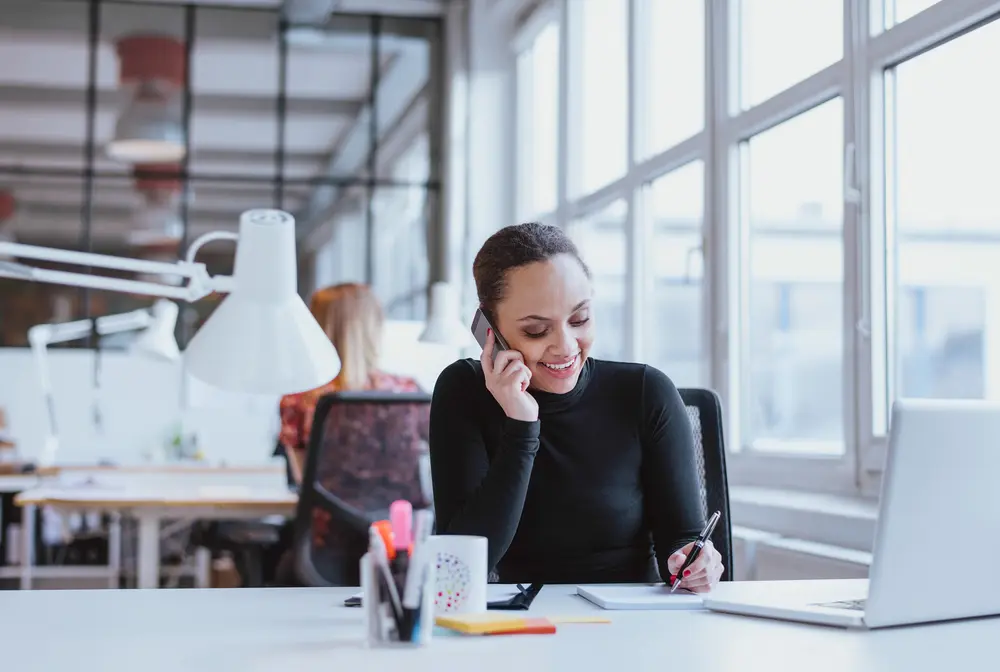 Woman answering the phone at a desk